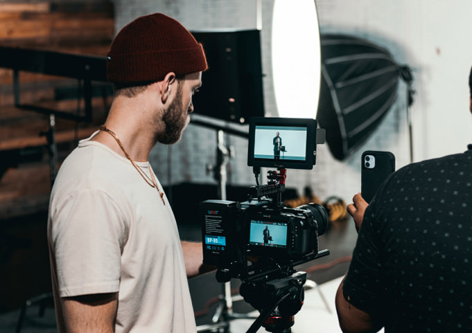 Man looking at video camera screen during a video shoot